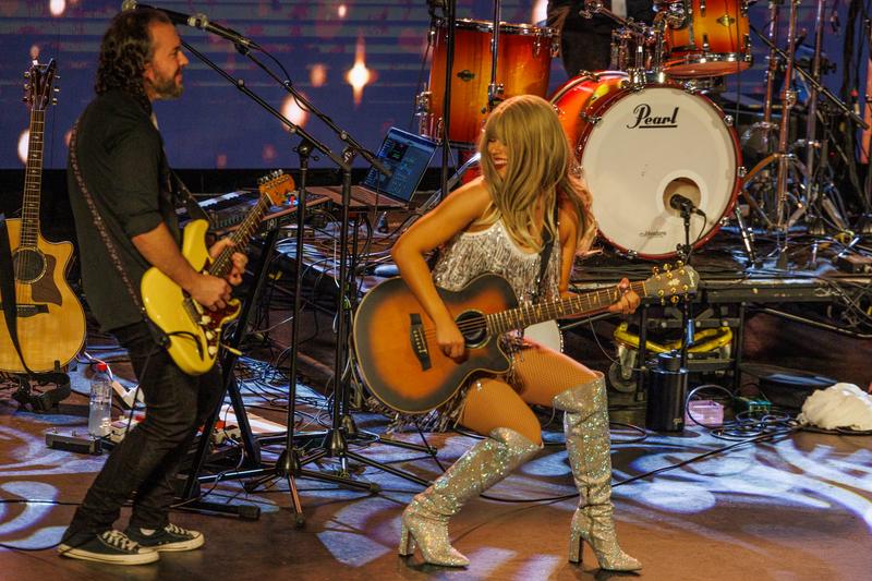 An acoustic moment on stage with the guitarist