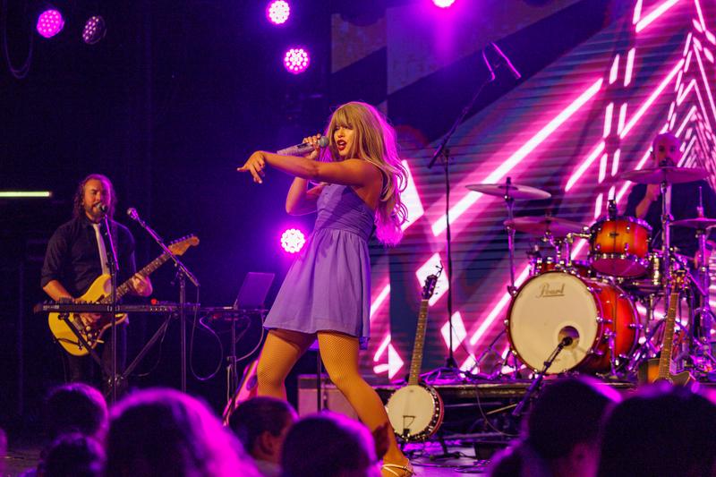 Purple dress, singing on stage with the band